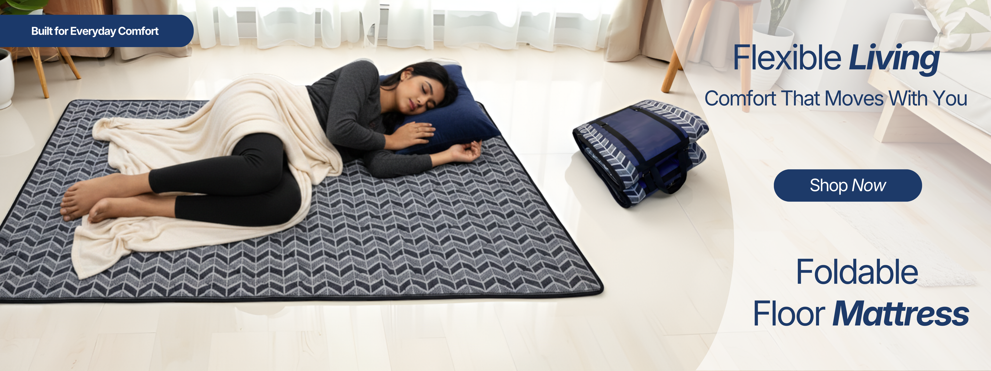 Woman lying on a foldable floor mattress in a room with promotional text for 'Flexible Living' and 'Foldable Floor Mattress'.