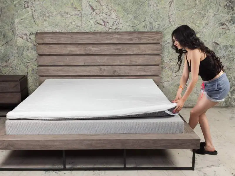 girl installing mattress topper